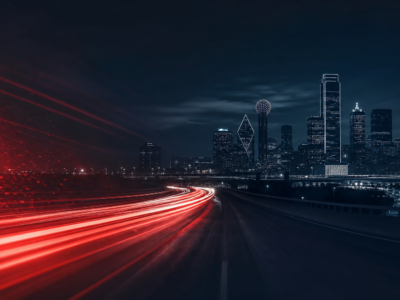 Dallas highway at night with car headlight trails — auto accident attorney near me in Frisco TX